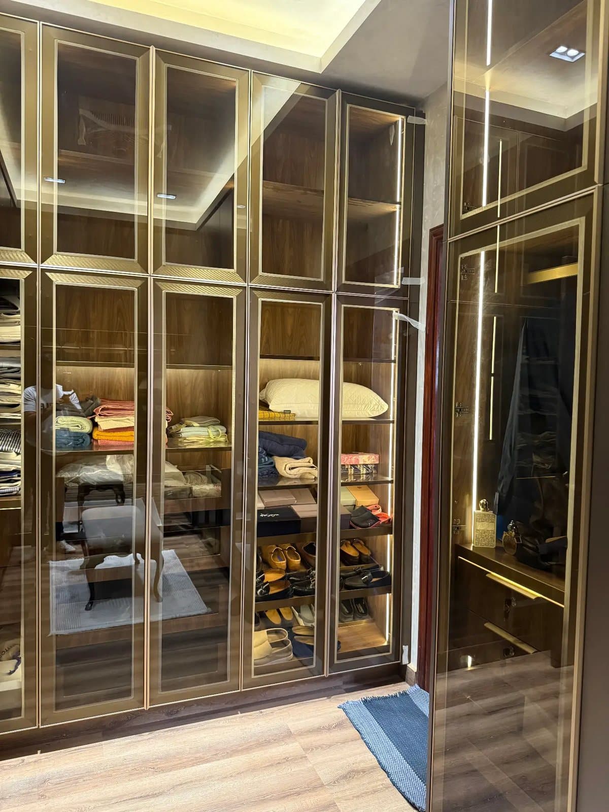 Gold profile glass wardrobe run by Amaza Homes