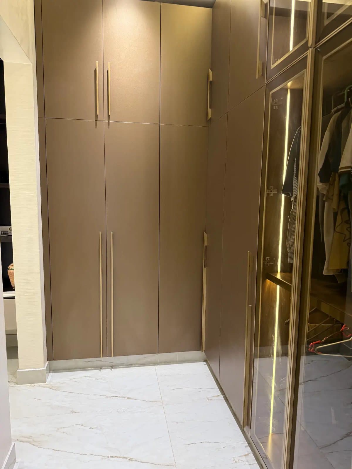Lit wardrobe interior by Amaza Homes